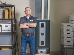 New furnace installation – Granite Bay Heating & Air HVAC technician standing beside a newly installed high-efficiency furnace in Granite Bay, CA