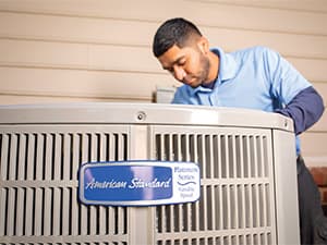 Professional AC installation by Granite Bay Heating & Air HVAC technician installing a new residential air conditioning system