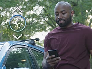 Control your home comfort remotely with a smart thermostat Homeowner adjusting a smart thermostat remotely from his phone for energy-efficient home comfort