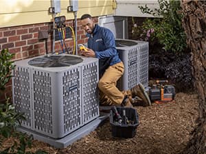 Seasonal AC maintenance service in Granite Bay HVAC technician performing preventative maintenance on two outdoor air conditioning units in Granite Bay, CA