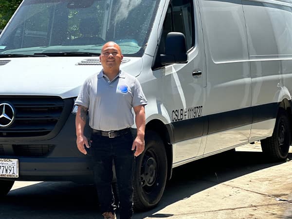 Sy of Granite Bay Heating & Air, standing in front of a company service van in Granite Bay CA Sy of Granite Bay Heating & Air, standing in front of a company service van in Granite Bay CA