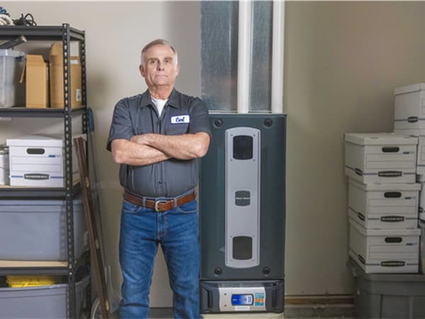 New furnace installation – Granite Bay Heating & Air HVAC technician standing beside a newly installed high-efficiency furnace in Granite Bay, CA