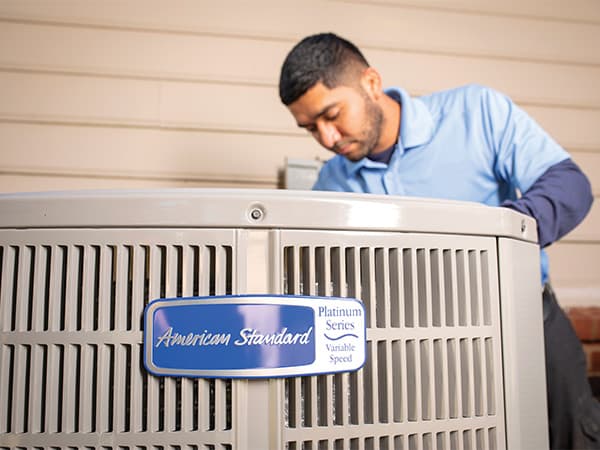 Professional AC installation by Granite Bay Heating & Air HVAC technician installing a new residential air conditioning system
