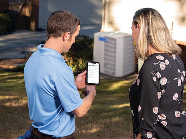 AC Repair & Replacement Consultation – Granite Bay HVAC HVAC technician reviewing air conditioner repair and replacement options with homeowner in Granite Bay, CA