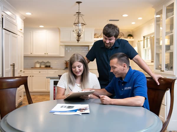 HVAC installation consultation and agreement Homeowner reviewing and signing an HVAC installation agreement for a new system