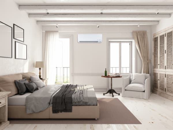 Ductless mini-split system for bedroom comfort Wall-mounted ductless mini-split system providing quiet heating and cooling in a cozy bedroom