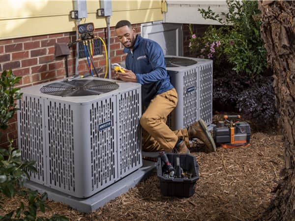 Seasonal AC maintenance service in Granite Bay HVAC technician performing preventative maintenance on two outdoor air conditioning units in Granite Bay, CA